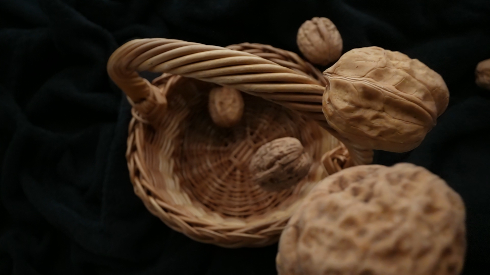 Walnuts Falling into Wooden Basket