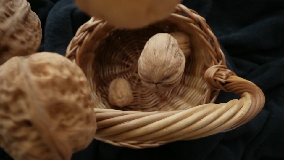 Walnuts Falling in Slow Motion into a Wooden Basket