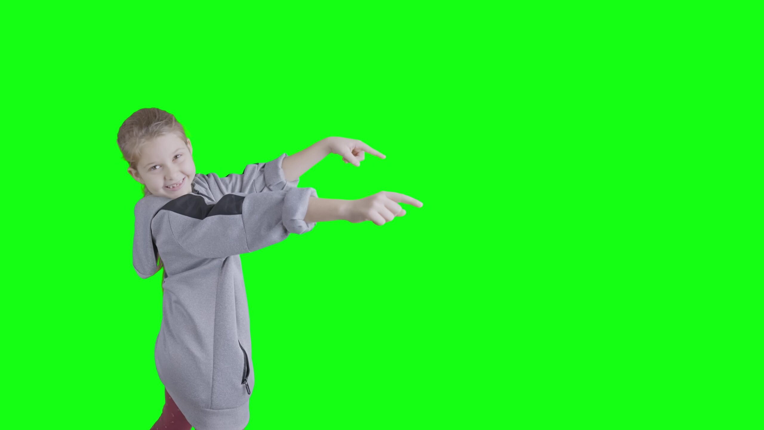 Happy Child Points and Smiles on Green Screen