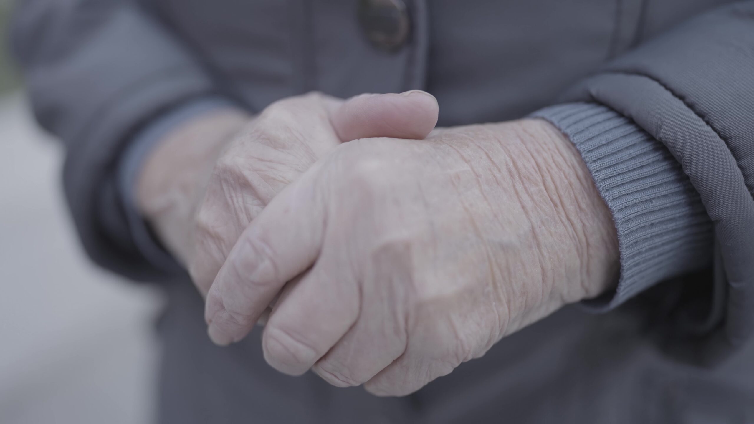 Close up of elderly womans hands in prayer gesture