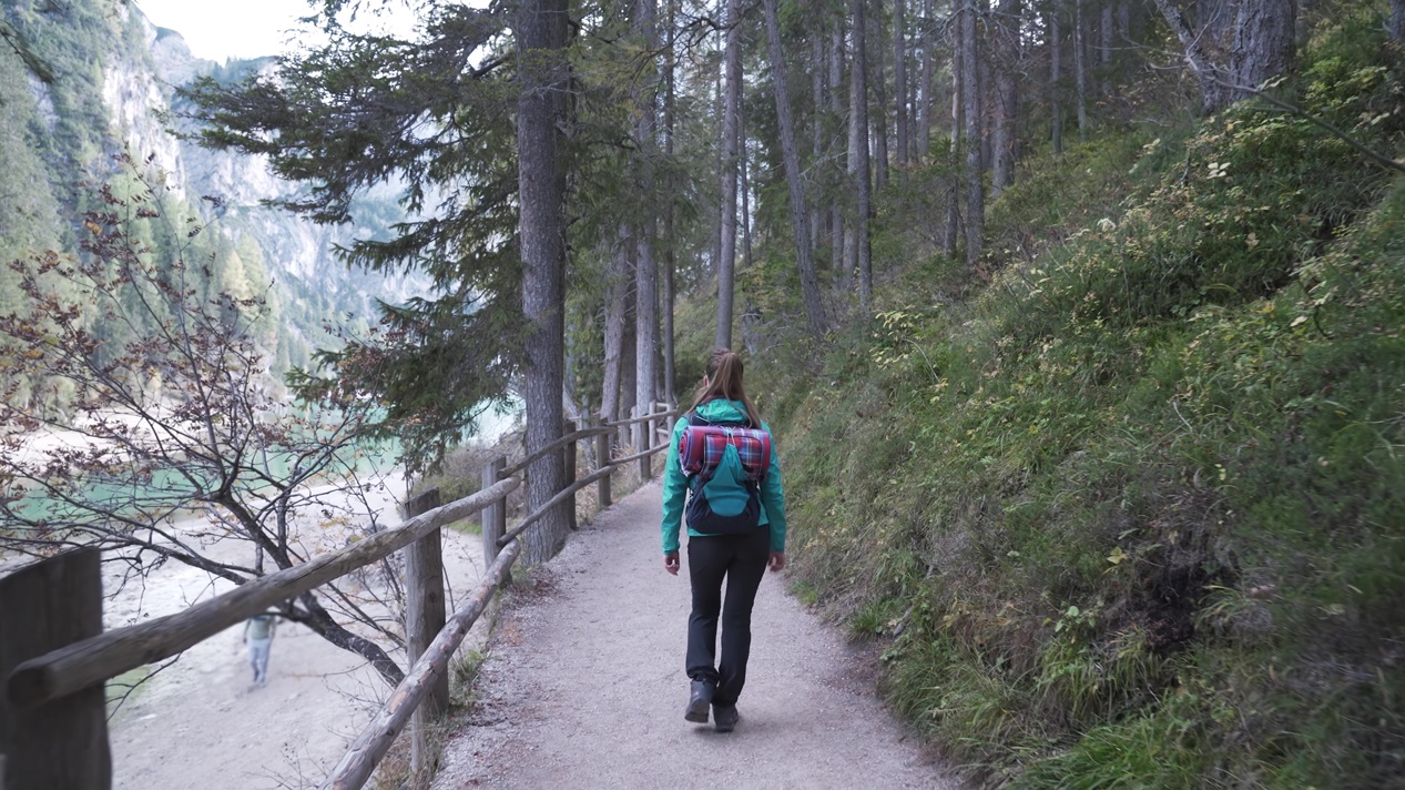 Woman walks on forest path