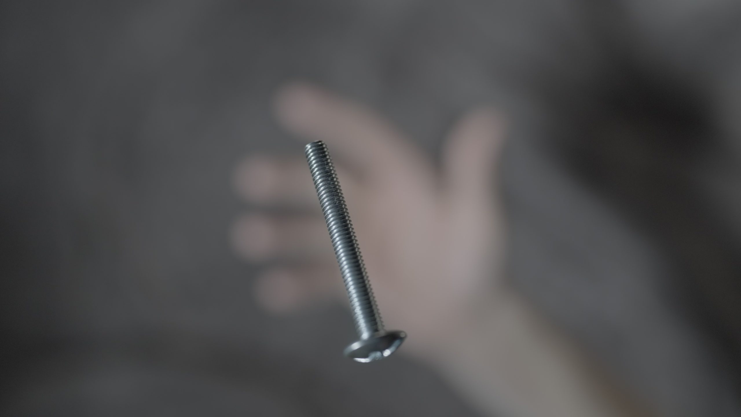 Screw thrown with hand up in macro