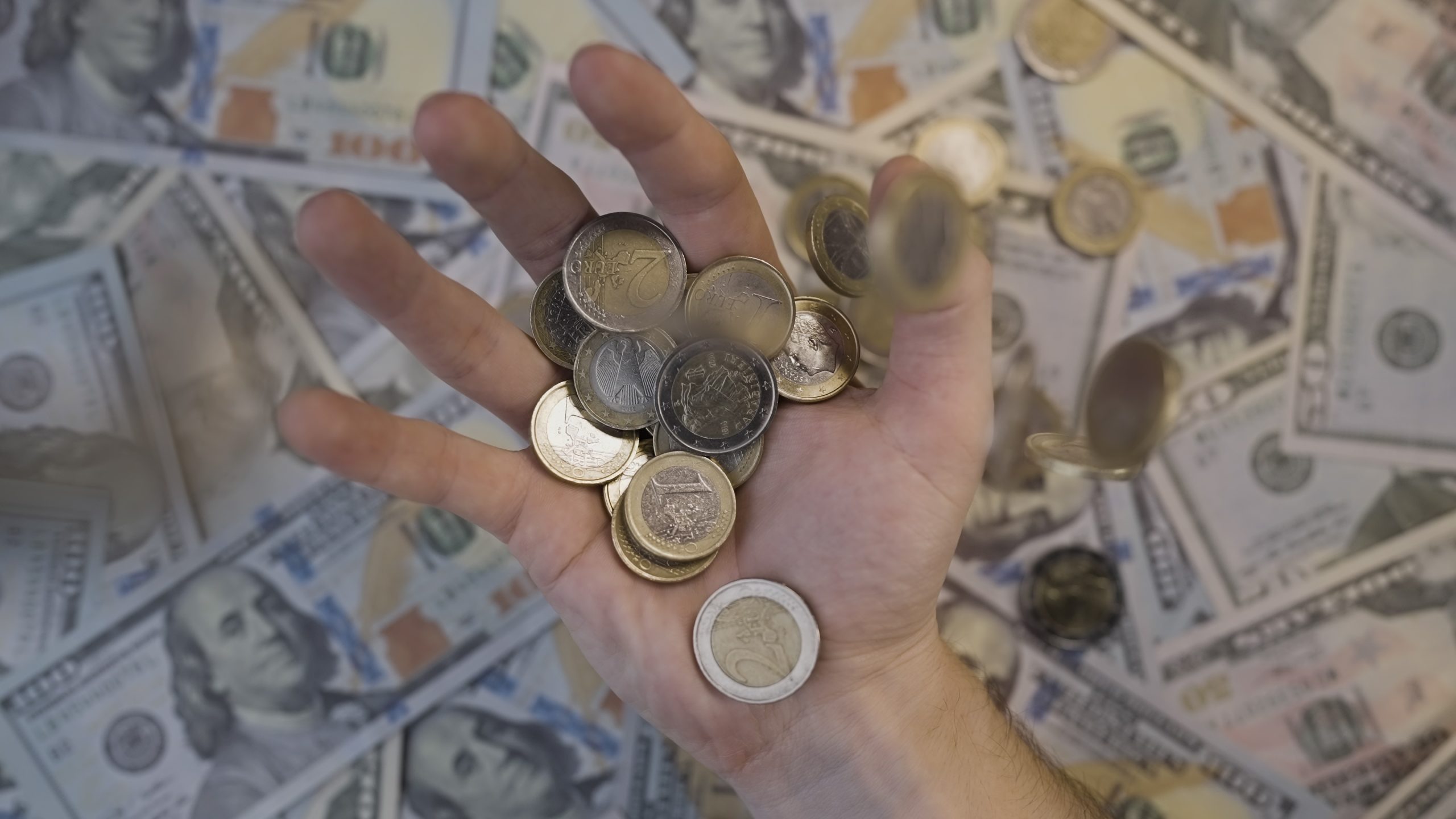 Money falls into the hand in slow motion