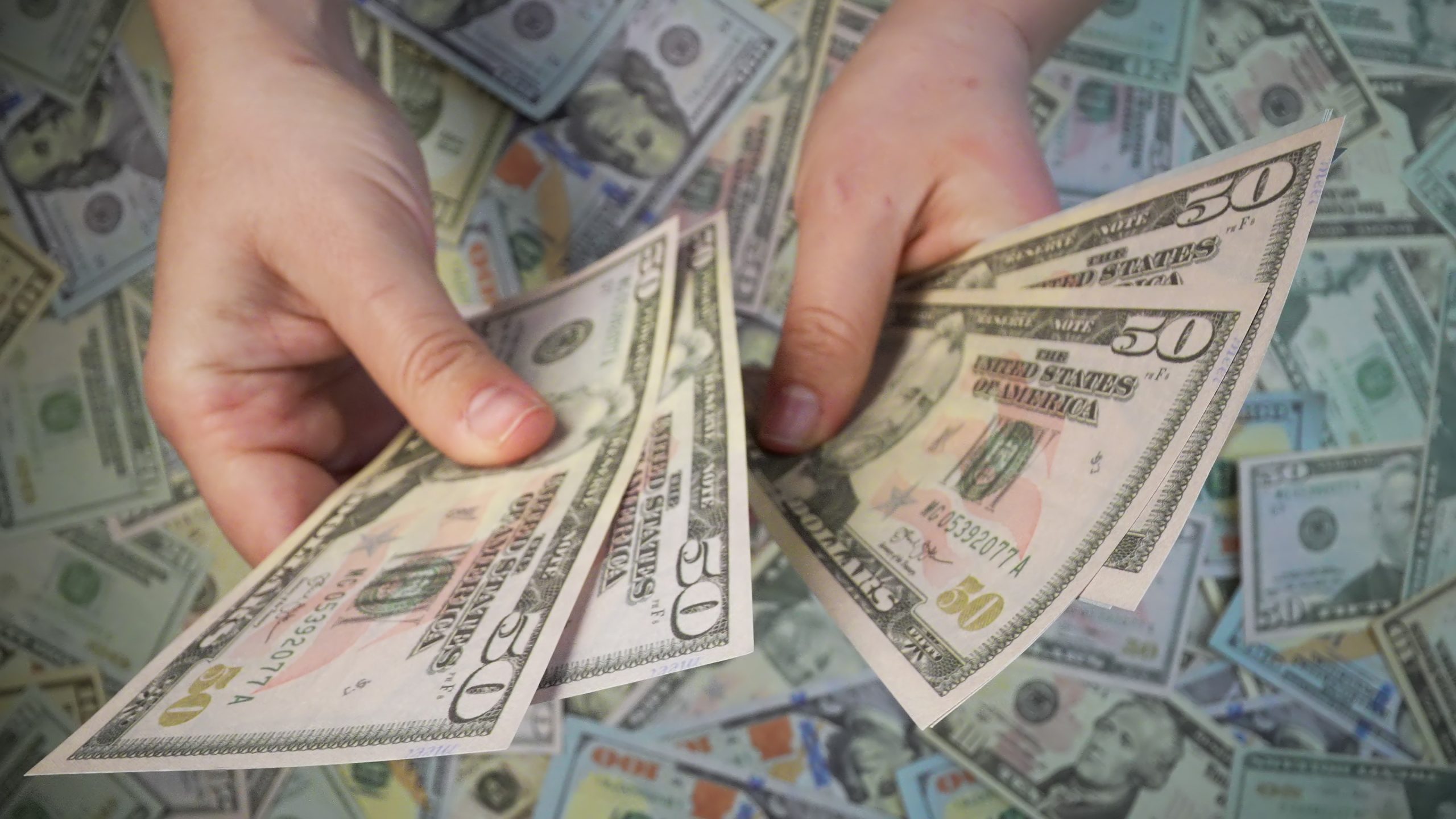 American dollars are counted with hands