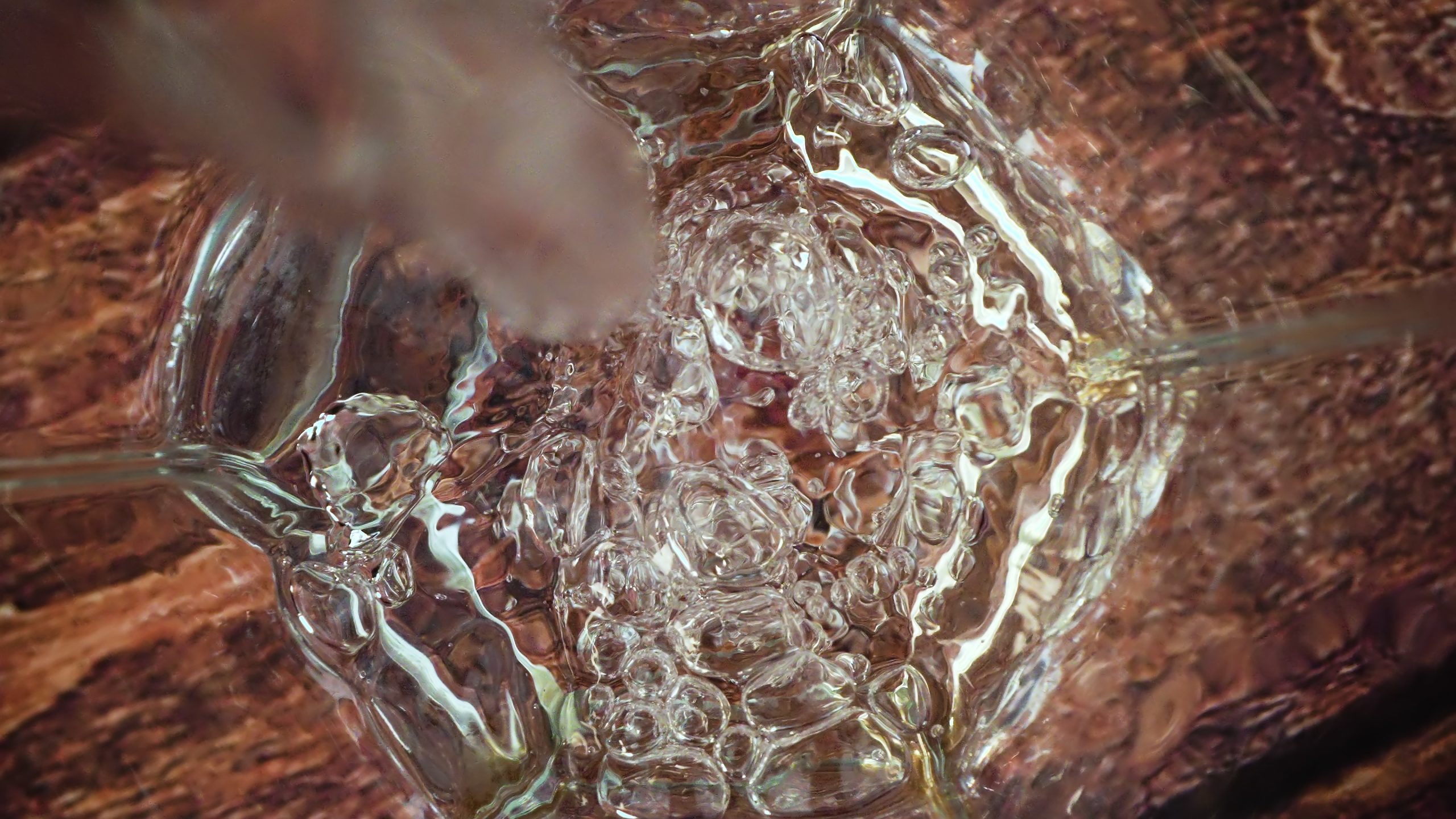 Water is poured in slow motion into the glass
