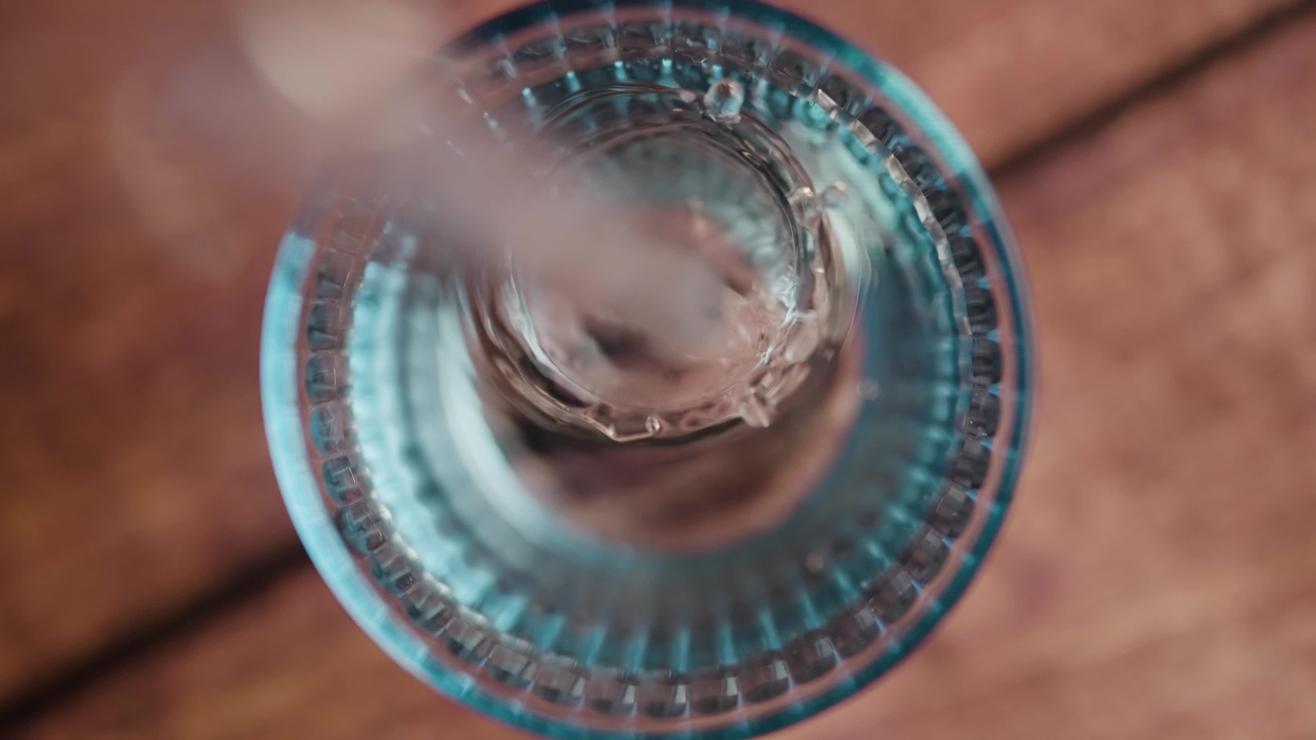 Water poured into the glass from above