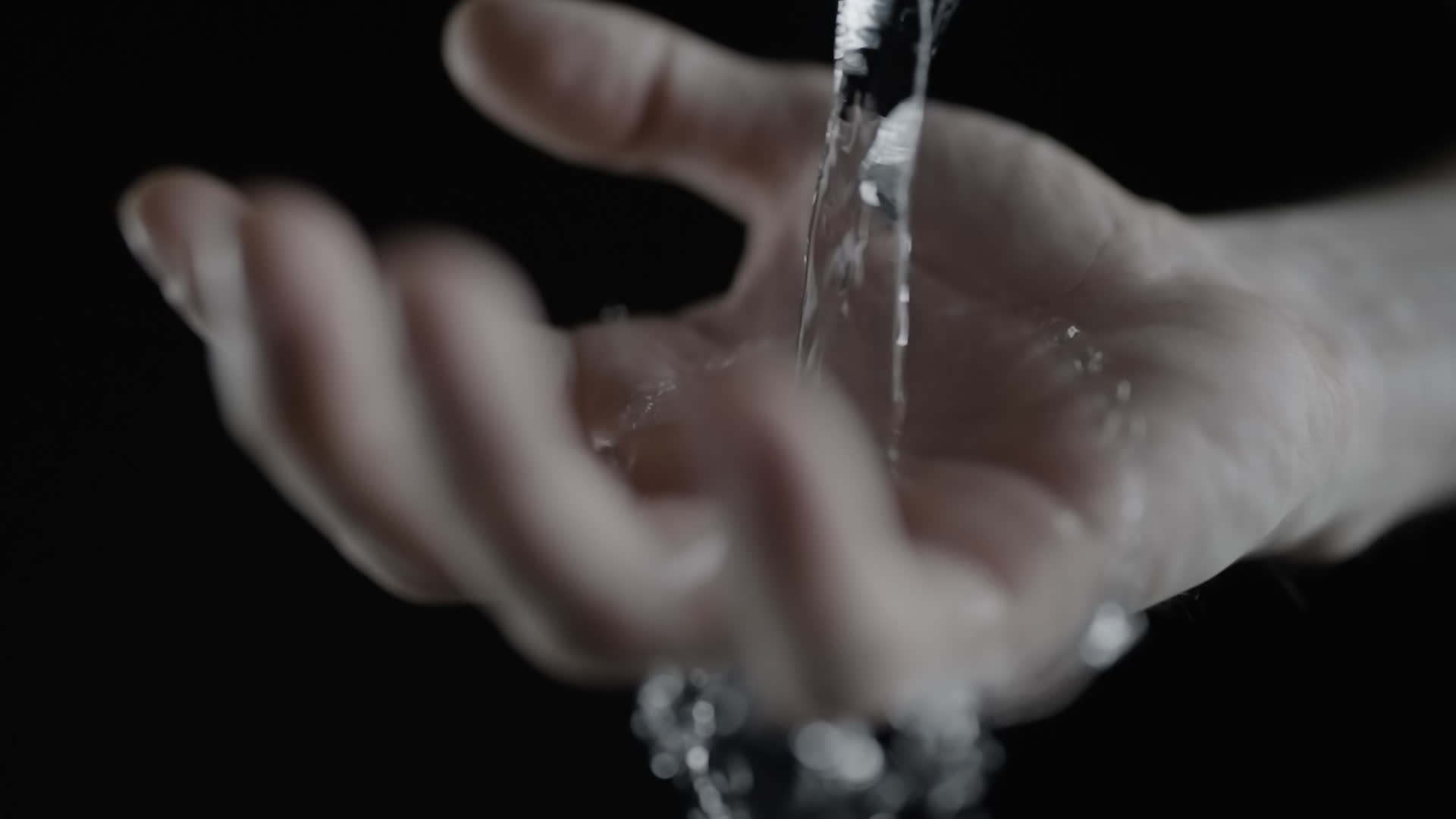 Water Cascading into an Open Hand