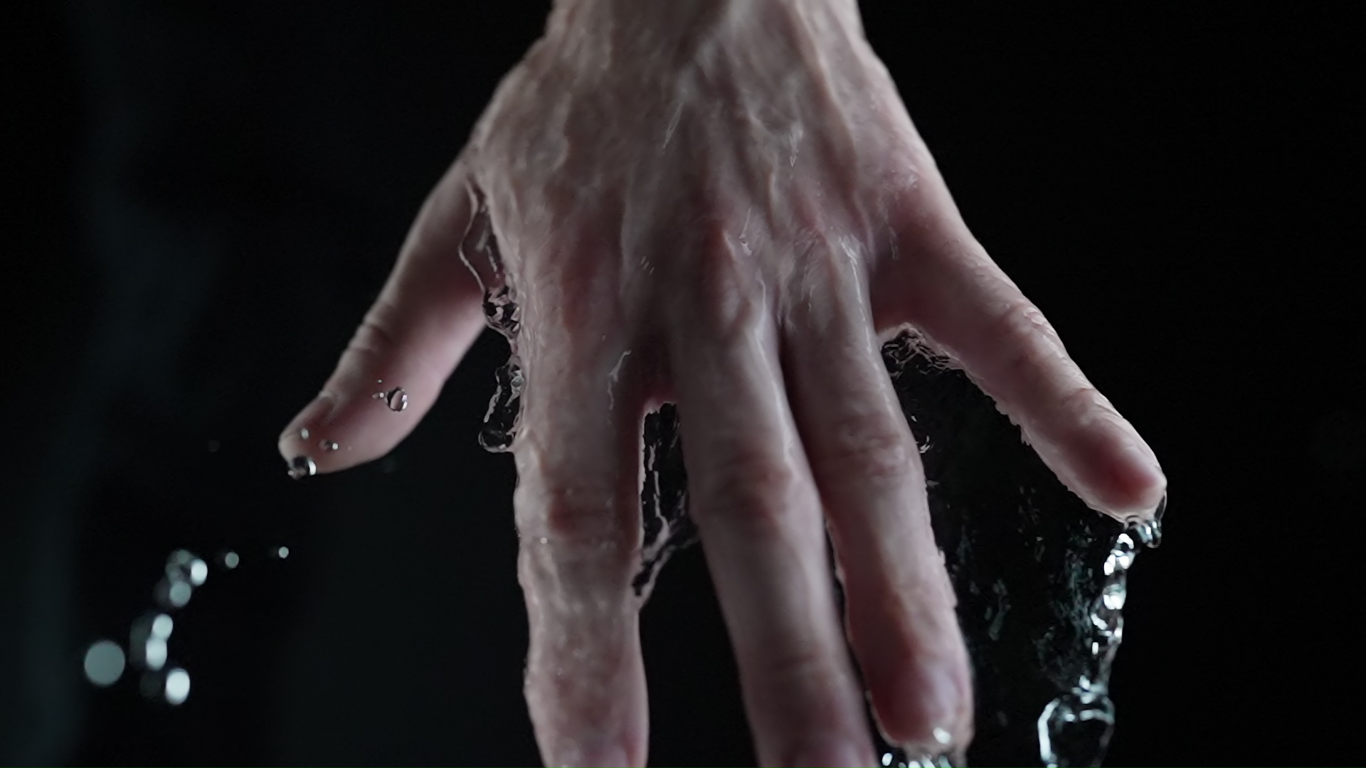 Hand Dripping Water in Dark Environment
