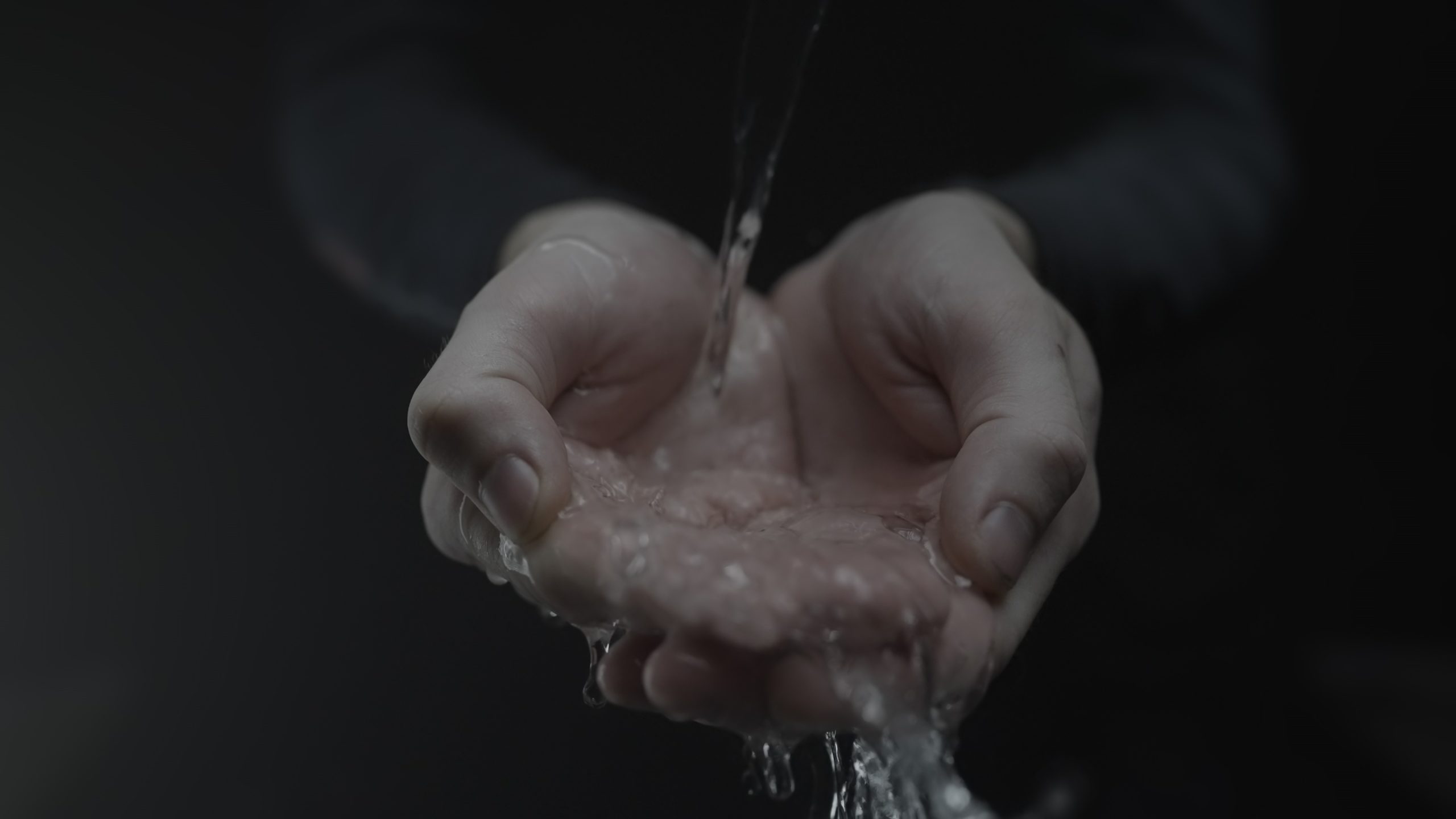 Hands Holding Flowing Water