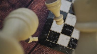 Chess Pieces in Mid-Fall over Board