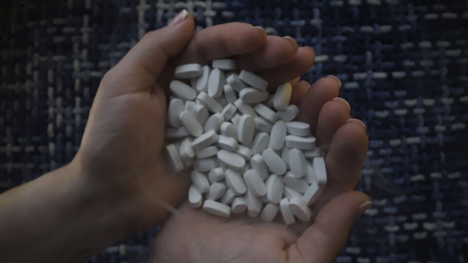 Hands Full of White Pills