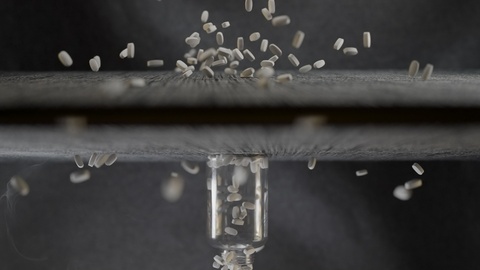 Rice grains falling into a bottle