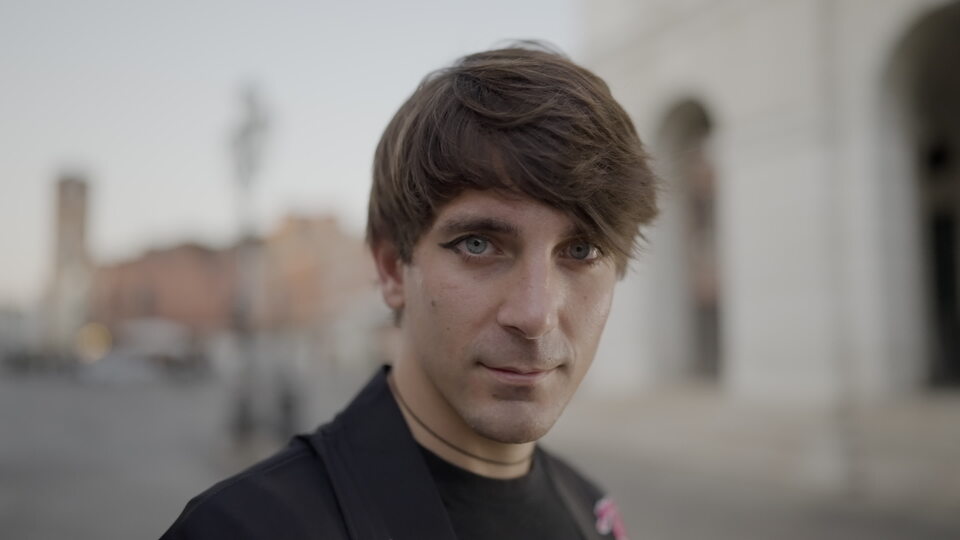 Young man with intense gaze in a city setting
