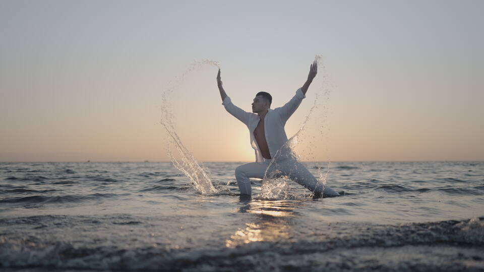 Dancer Splashing Water at Sunset on the Beach