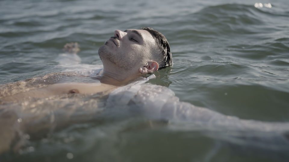 Person Floating Calmly on Water with Eyes Closed