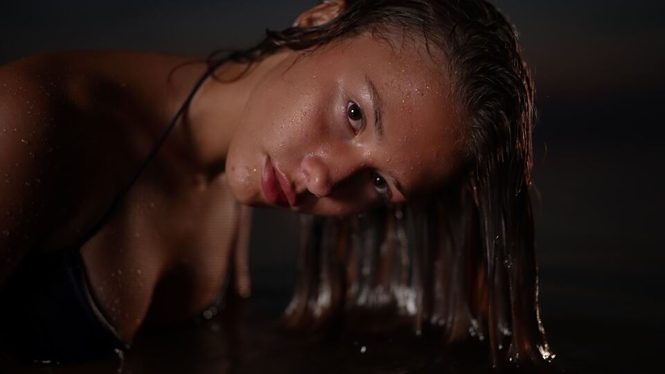 Woman with Wet Hair Leaning Forward, Intense Gaze
