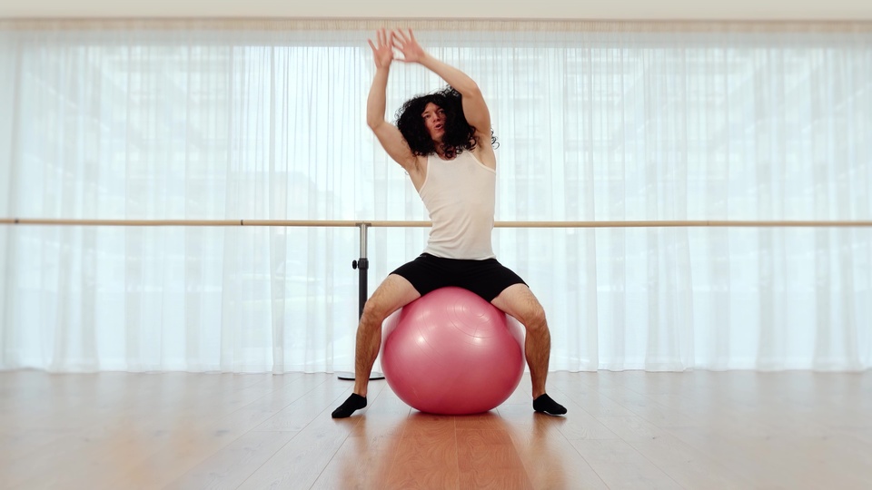 Man Exercising on a Pink Fitness Ball