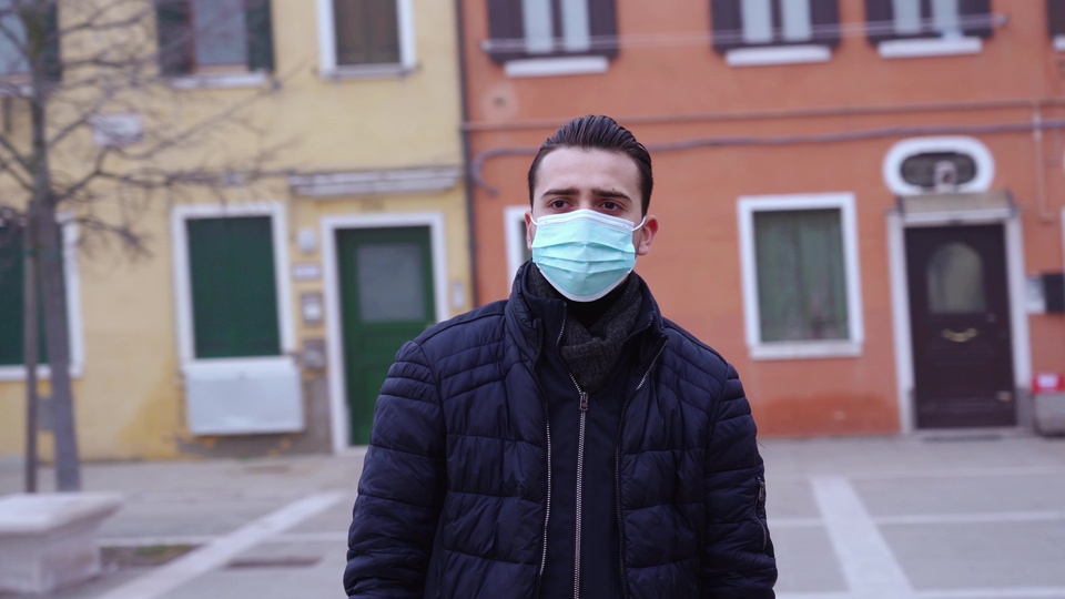 Man Wearing a Face Mask in an Empty Town Square