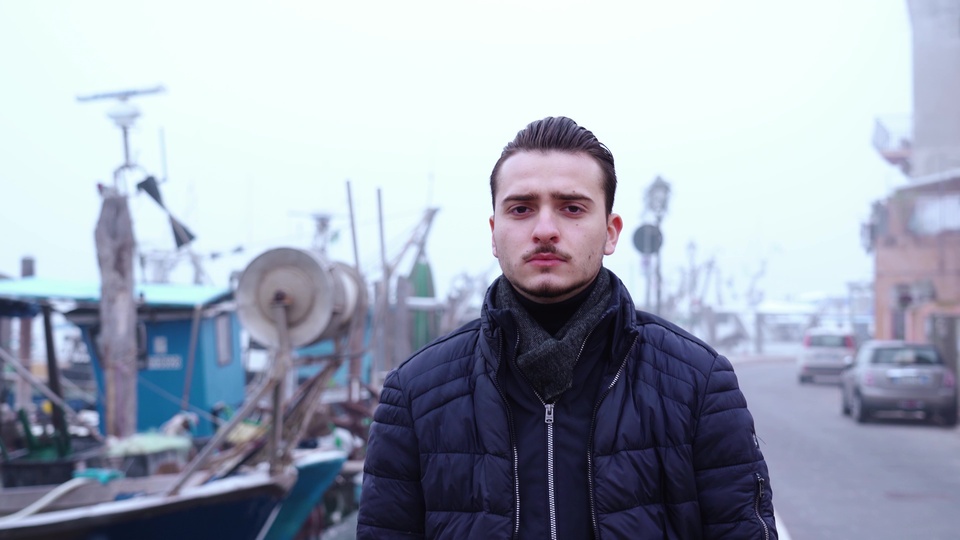 Man Standing by a Foggy Harbor
